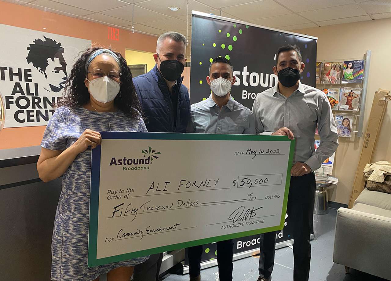 astound handing a giant check to ali forney