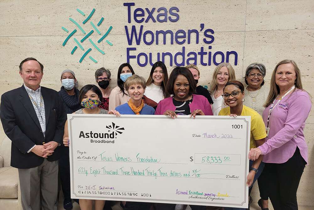 astound handing a giant check to texas women's foundation