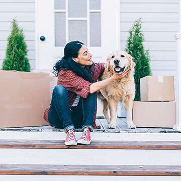 woman sitting on step with dog