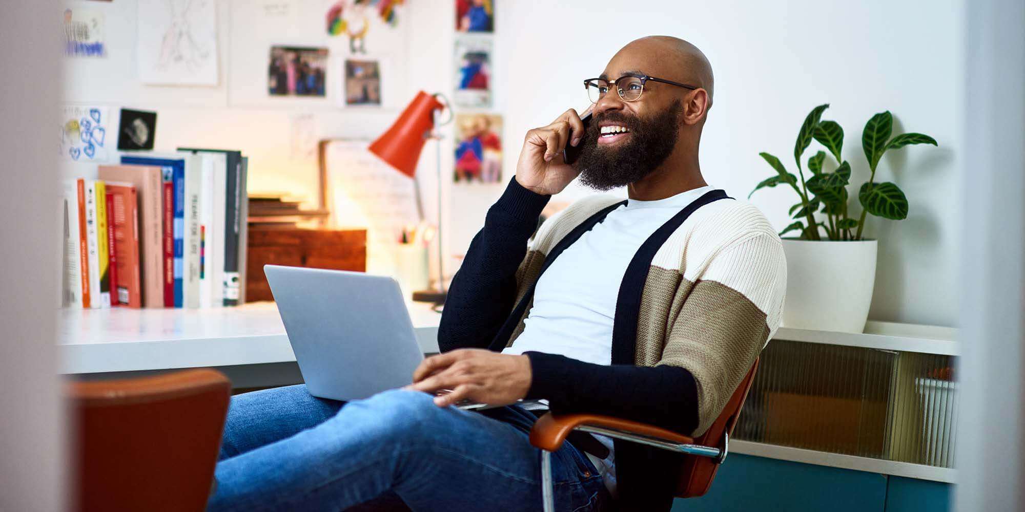 Man working in office on the telephone - Astound voicemail service has all the features you need to work from anywhere