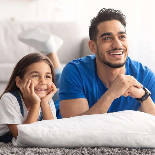 Dad and daughter watch streaming TV