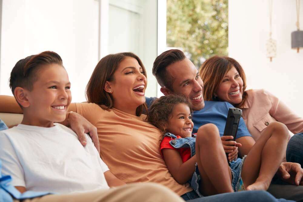 Family on a couch enjoys watching together