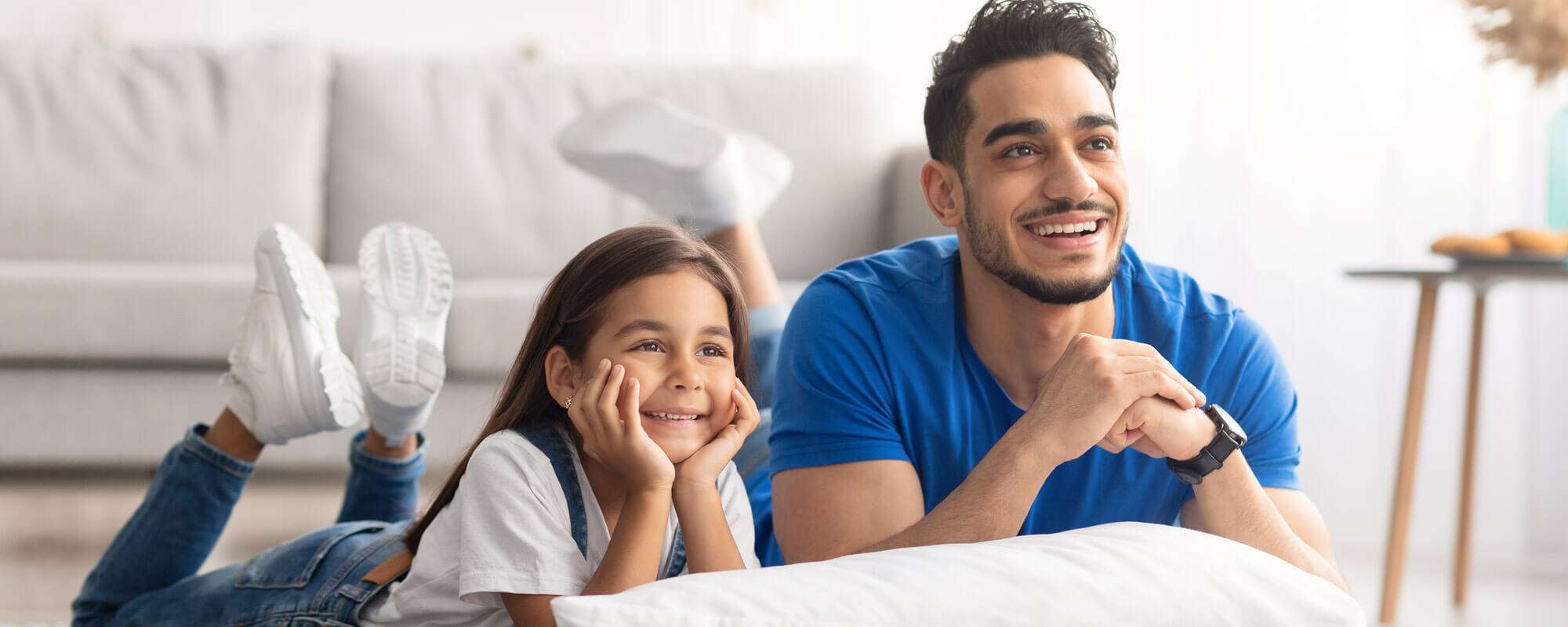 Dad and daughter watch TV