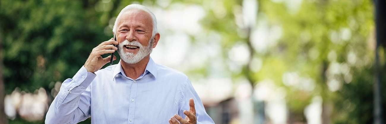 Man walking in the outdoors talking on his mobile device