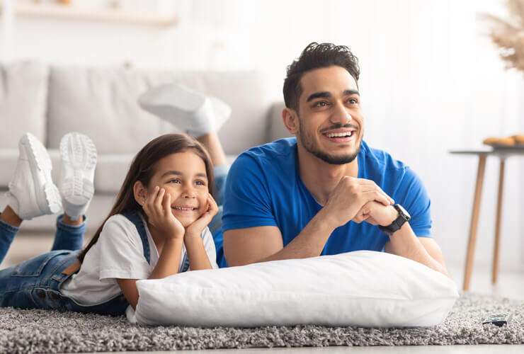 Dad and daughter watch TV