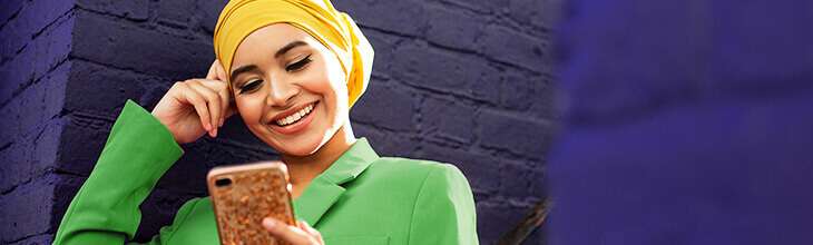 Brightly dressed woman uses mobile phone