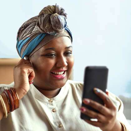Stylish woman in a headwrap makes an international call