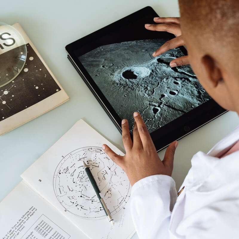 Secure your family's devices - young boy studies planetary science on a tablet