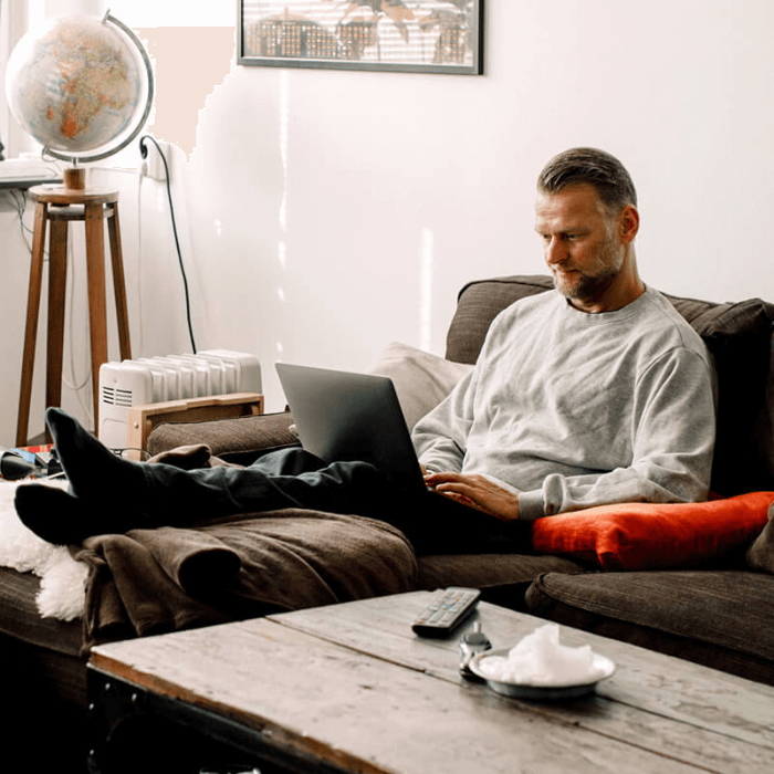 man sitting on couch working form home
