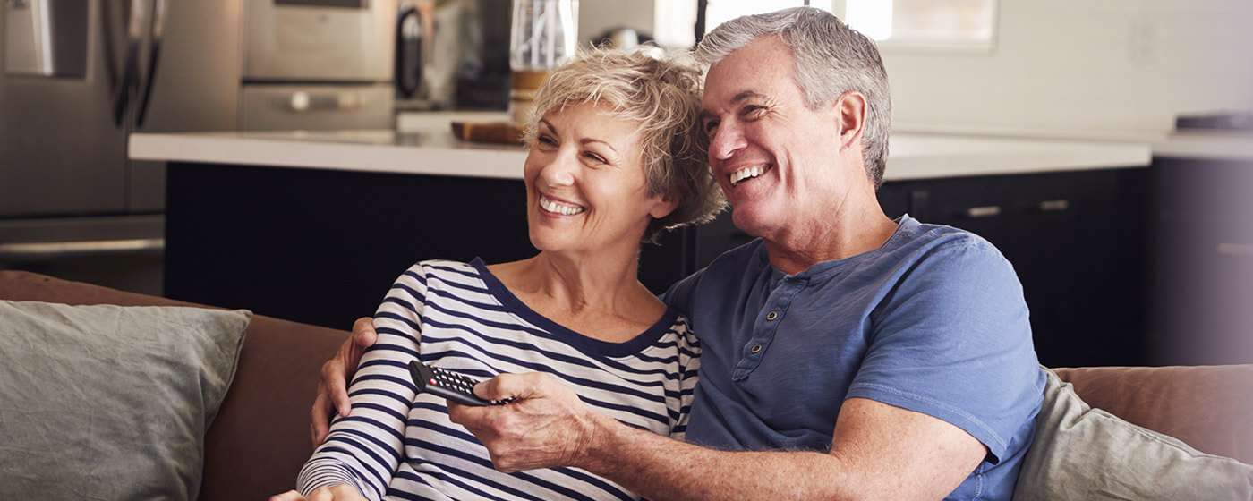 Couple watching TV at home