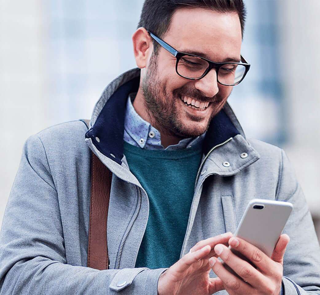 man smiling at his phone