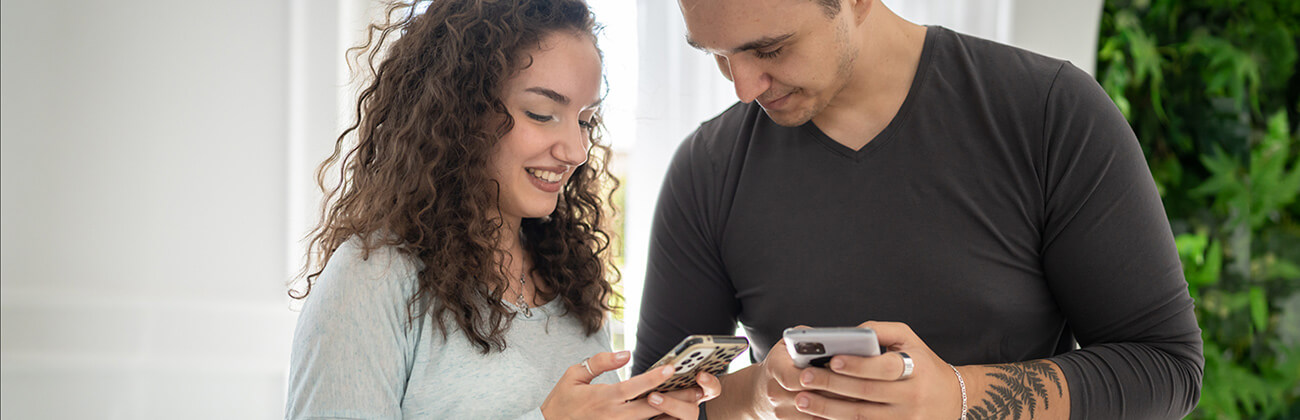 Couple looks at their mobile phone