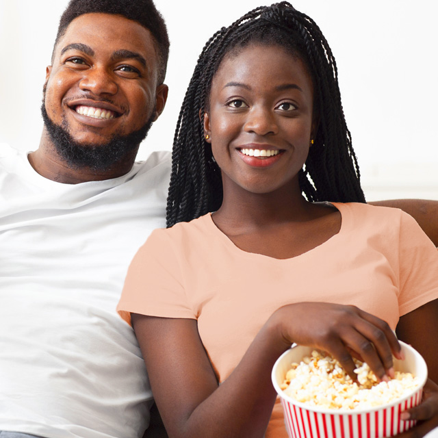 Couple with popcorn watches the latest fall shows