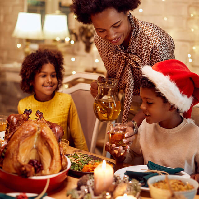 Mom puts holiday dinner on the table for the family celebration