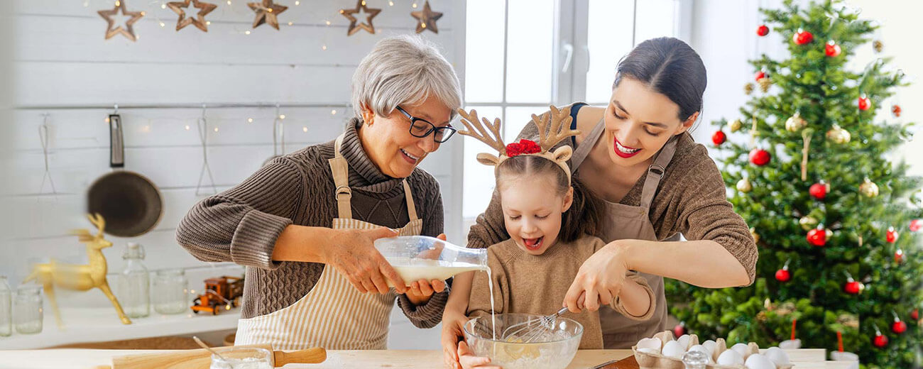 Astound holiday gadget guide - three generations bake together in a holiday decorated kitchen
