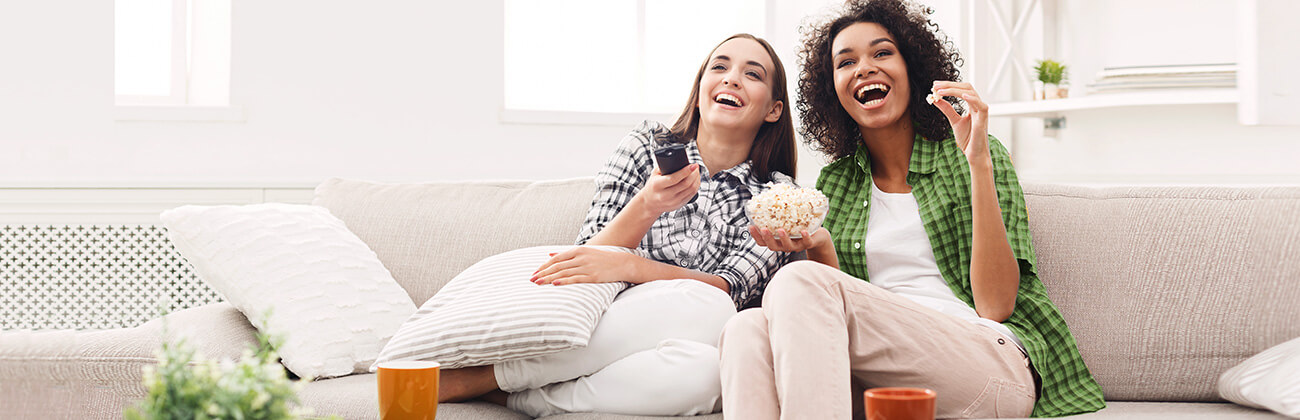 Women Couch With Remote Watching TV
