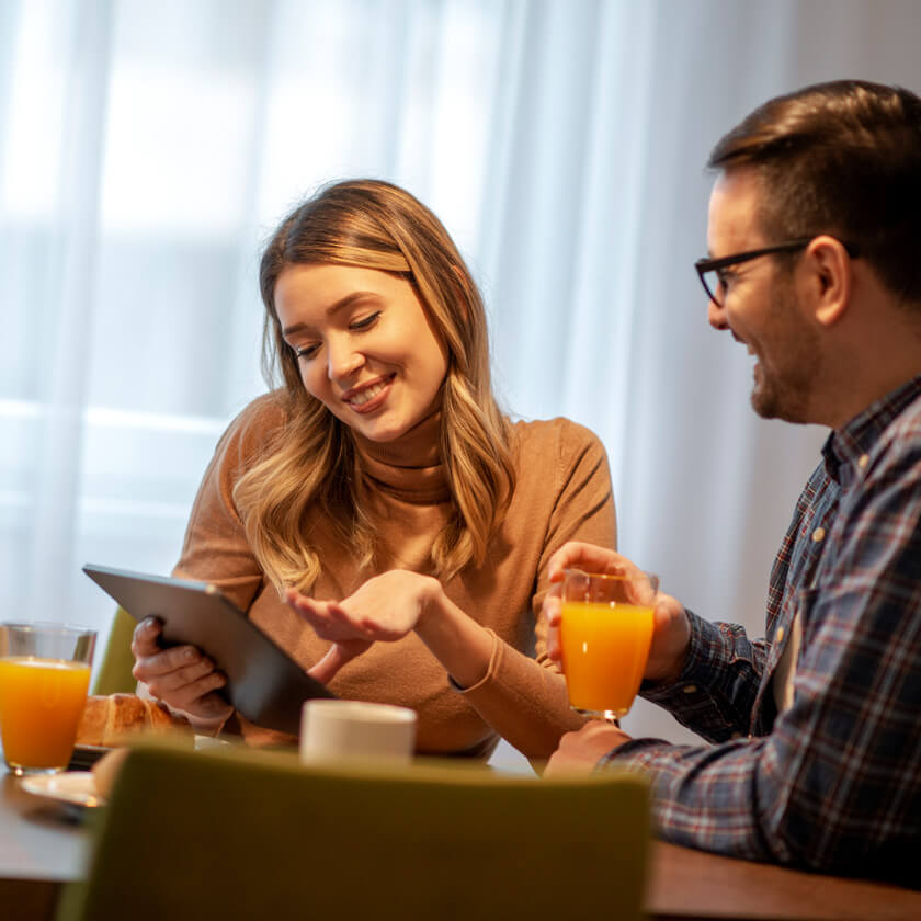 100 Mbps - couple enjoys catching up on news online at breakfast