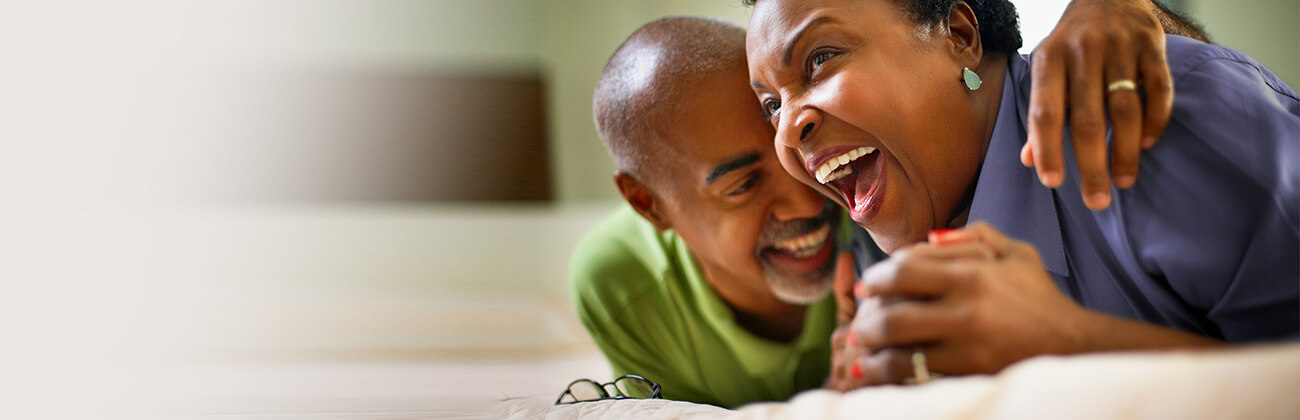 Mature couple laughing together at home