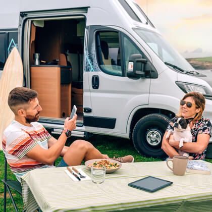 travelers in RV with multiple devices