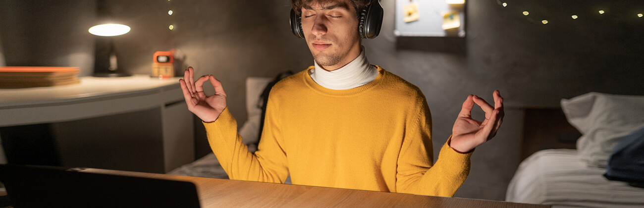 Man at laptop meditates while waiting for slow connection