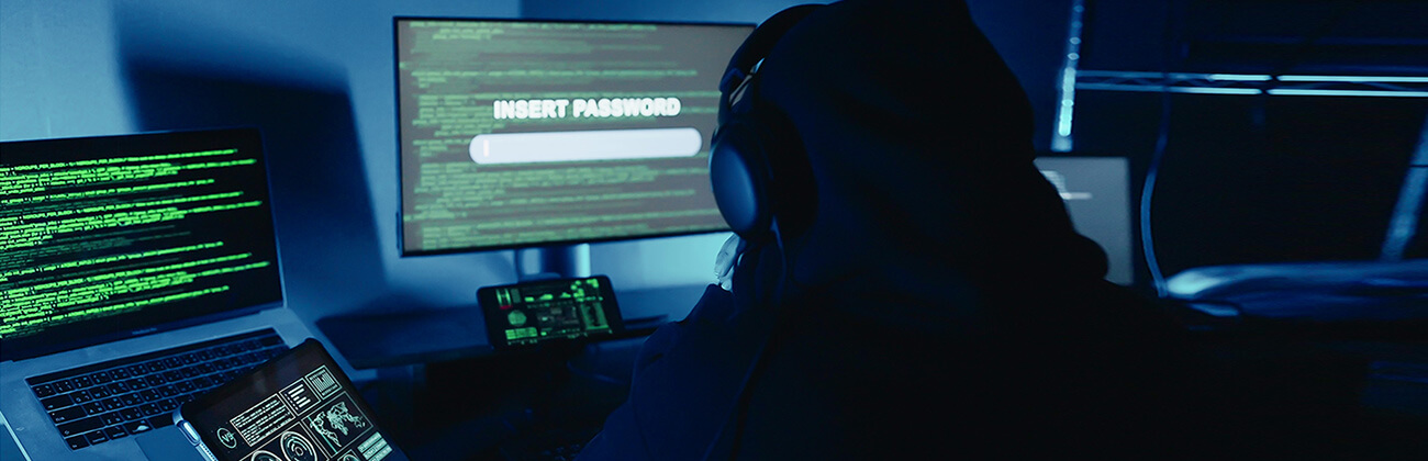 eSIM hacker viewing multiple screens to steal data