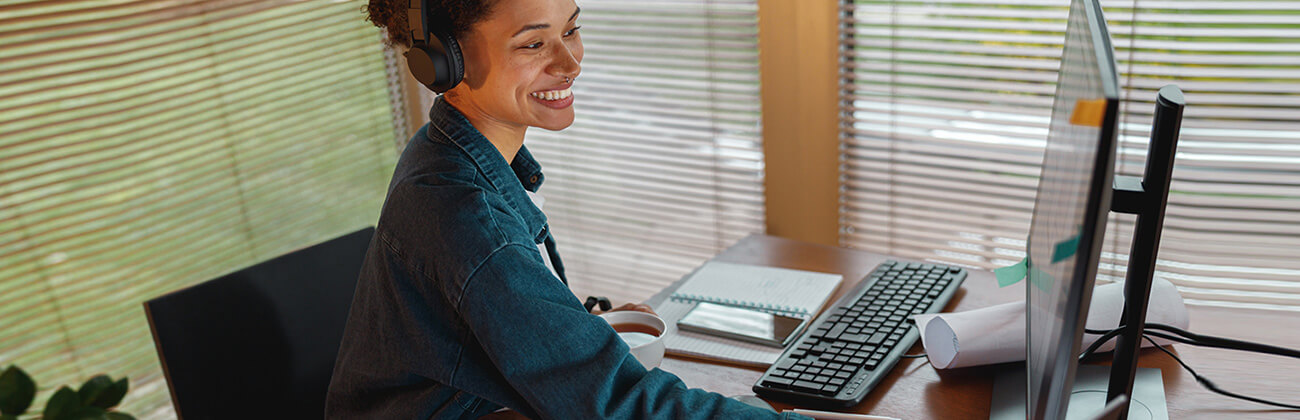 Young creative professional woman uses multiple devices in her home office