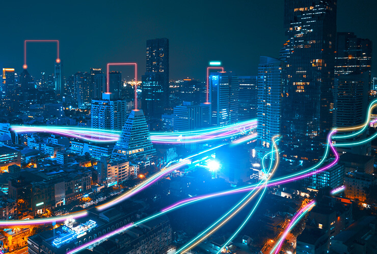 streams of light going through a nighttime city symbolizing the speed of fiber connections