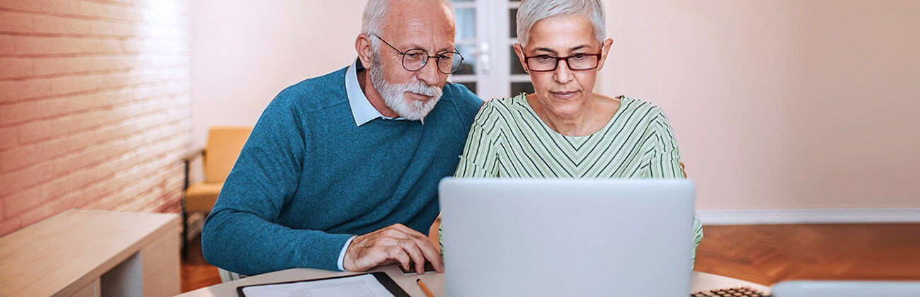 Senior couple on a laptop use Astound's security checklist to ensure their home internet safety
