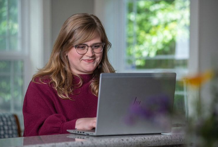 woman at laptop tests internet speed