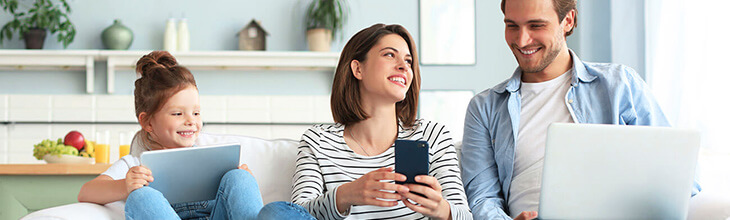 family of three on their electronics