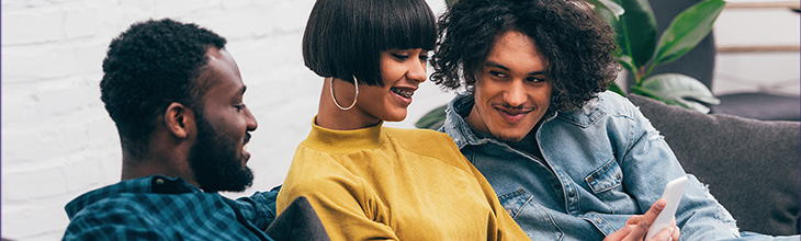 Three friends use mobile data to watch YouTube on a cell phone