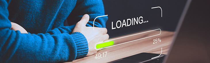 man at a laptop waiting for slow load times