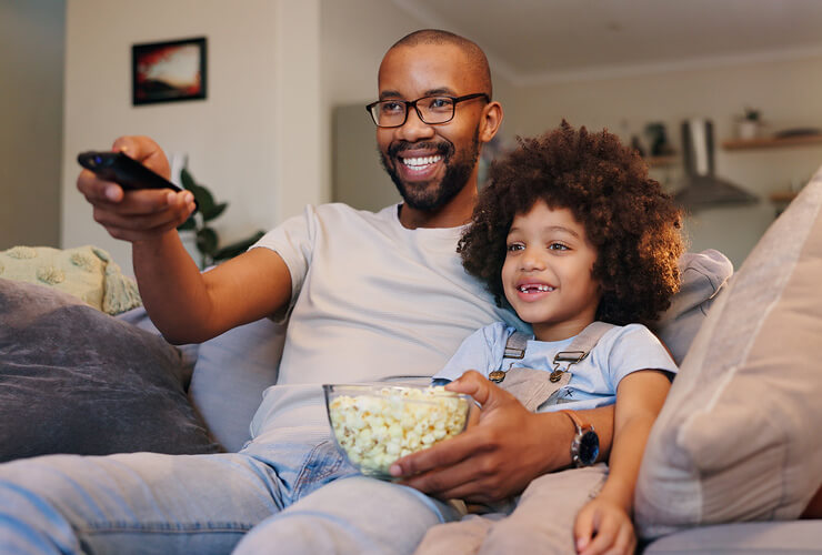 Dad and son watch shows together