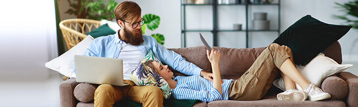 couple on sofa using wifi