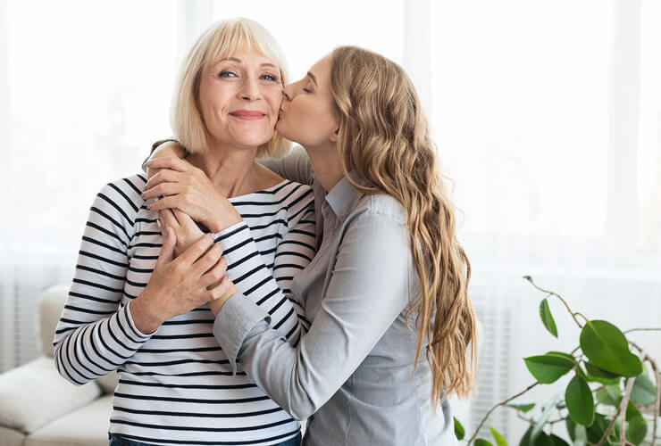daughter hugs and kisses Gram on the cheek for Mothers Day