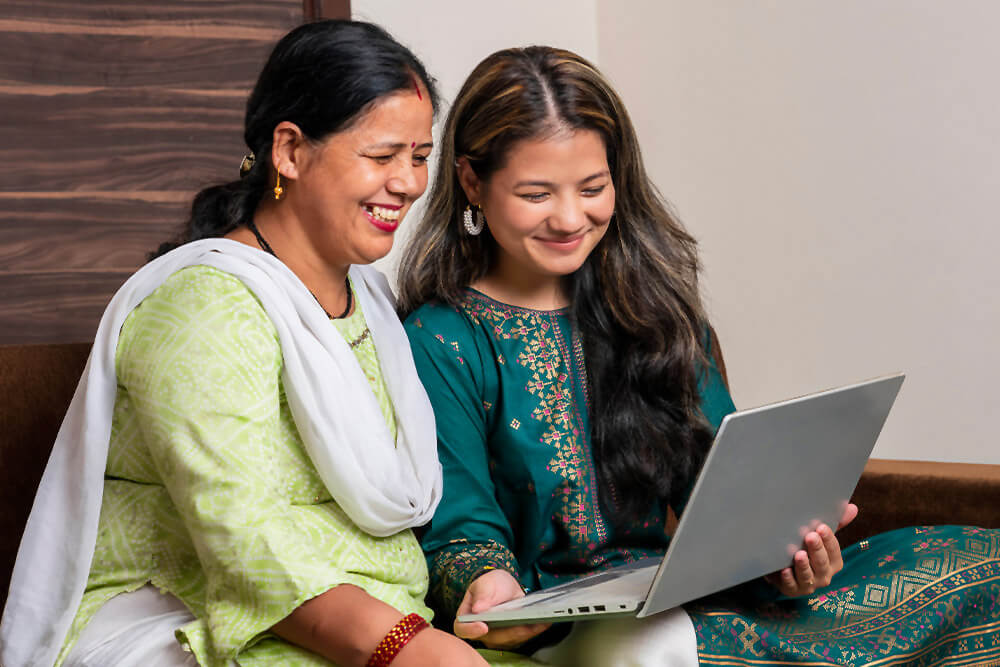 Mother and daughter dressed in traditional saris learn more about AAPI Heritage Month