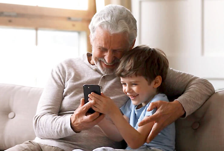 Best phone for kids - Boy and grandpa look at mobile phone together
