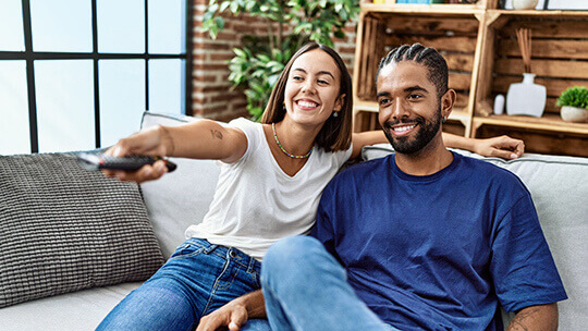 couple watching DIRECTV package