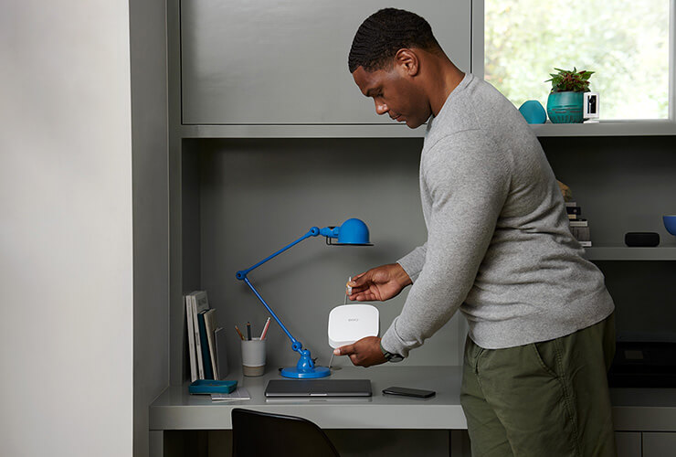 African American male plugging in a eero device